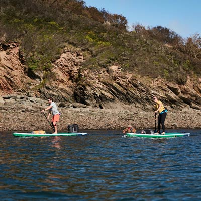 two people paddle boarding
